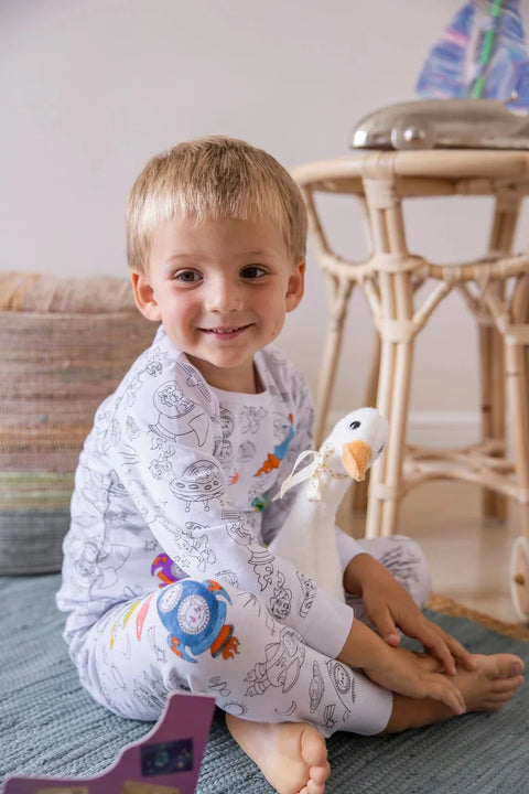 Smiling baby boy with plush toy Henry The Goose