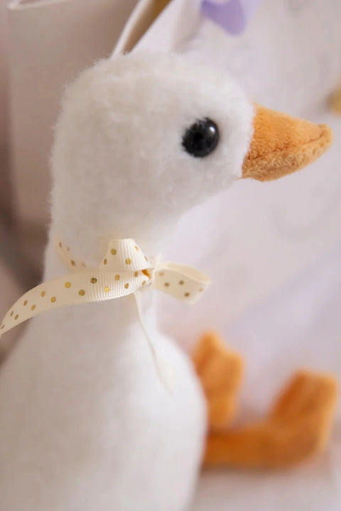 A close-up view of the plush Henry the Goose toy.