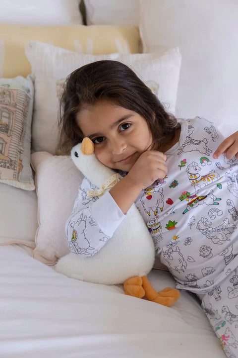 Smiling baby girl with plush toy Henry The Goose